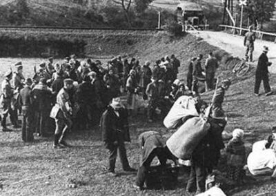 Wyrzuceni z domów Polacy oczekują w punkcie zbornym na transport samochodowy (widoczny już na drugim planie) do obozu zbiorczego. Miejscowość Sól, przedpołudnie 24 września 1940 r.